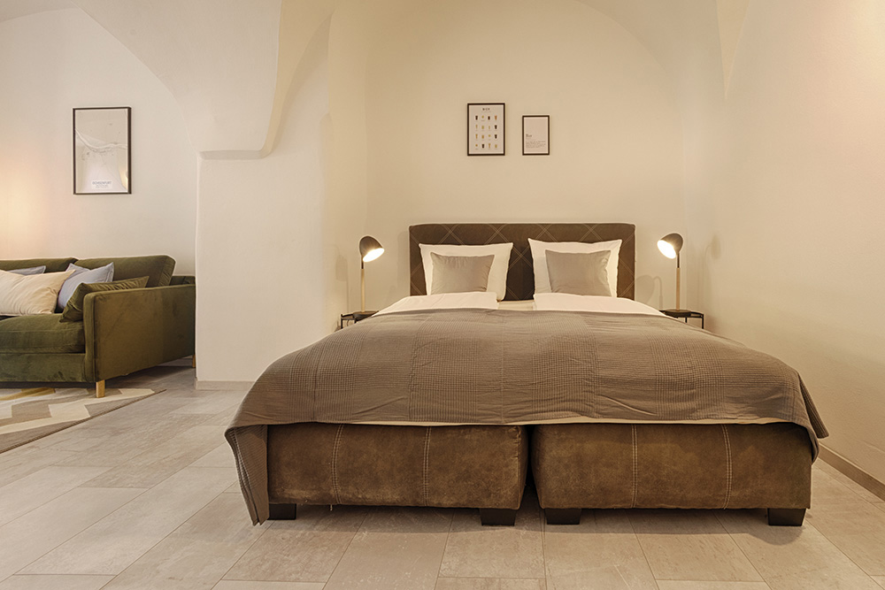 Minimalistisches Schlafzimmer einer Ferienwohnung in Würzburg mit Gewölbedecke
